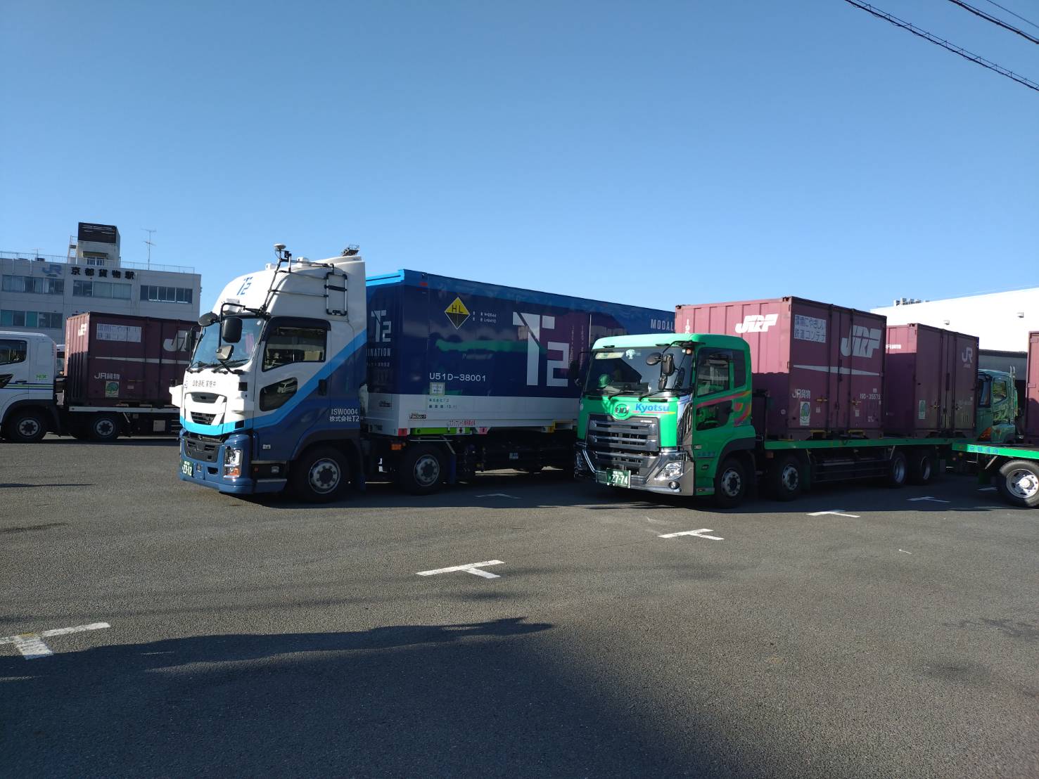 T2のトラックから共用コンテナを積み替える様子